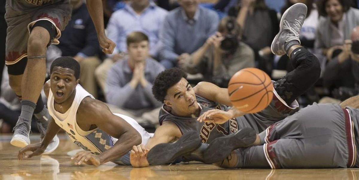 North Carolina’s Kenny Williams (24) and Boston College’s Jerome Robinson (1) hit the court after a loose ball during the first half on Tuesday, January 9, 2018 at the Smith Center.
