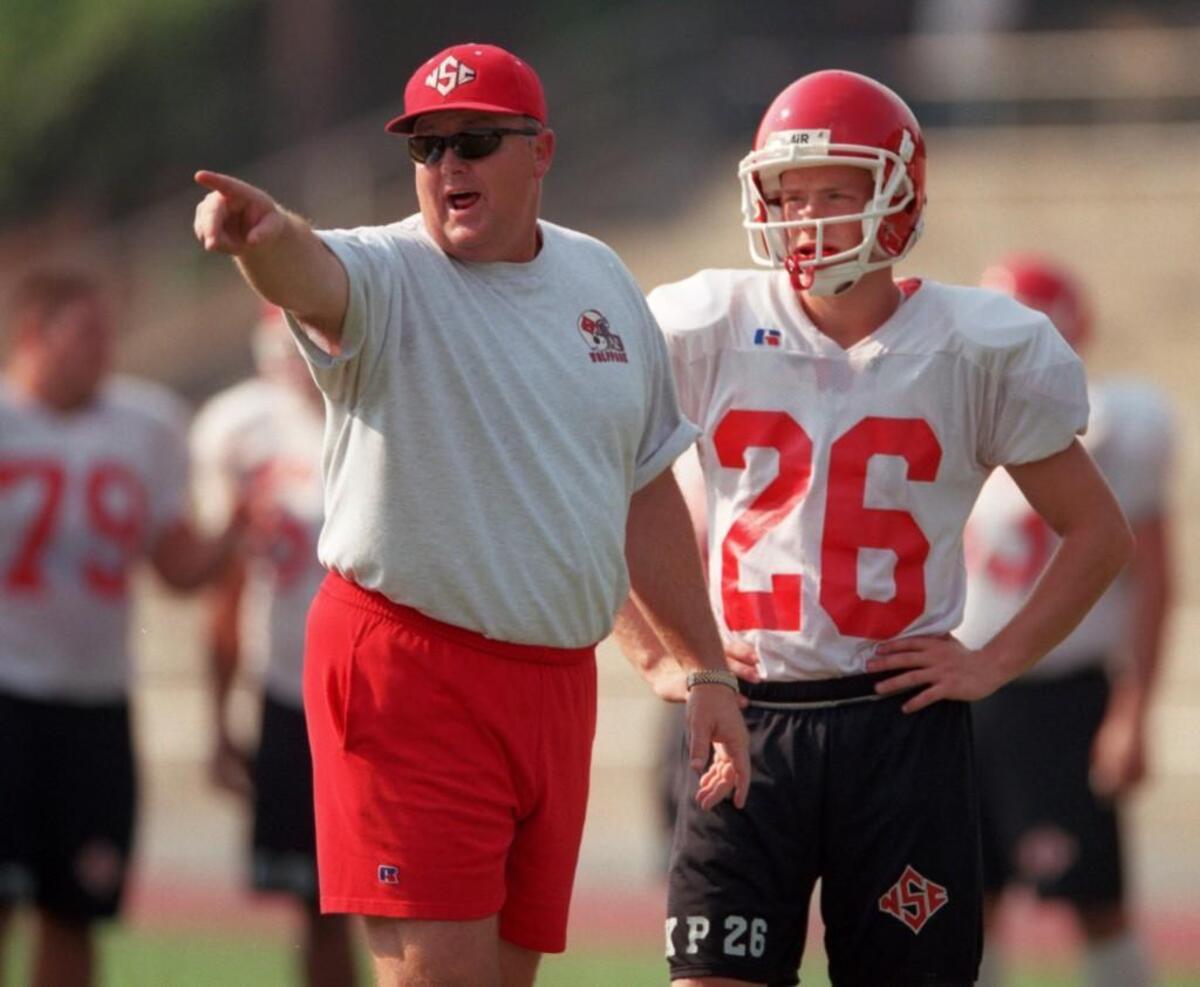 Former N.C. State assistant coach Robbie Caldwell and kicker (26) Kent Passingham
