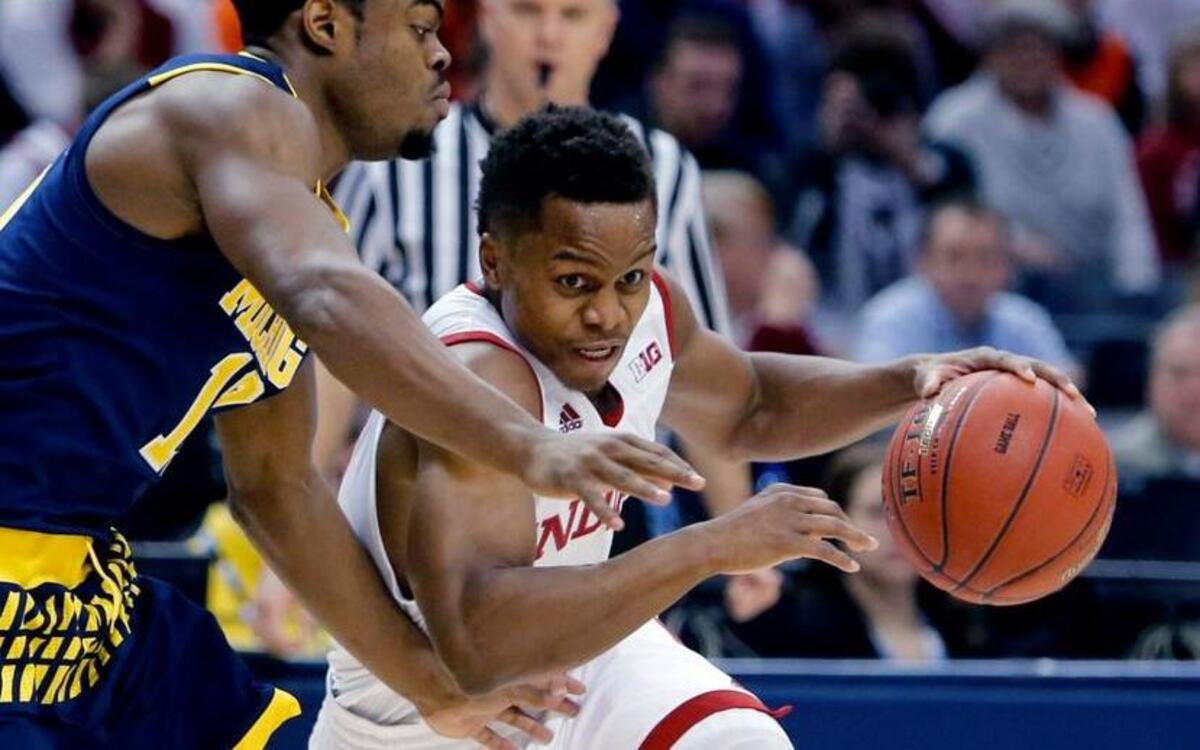 Indiana's Yogi Ferrell (11) drives against Michigan's Derrick Walton Jr. (10) in the first half of an NCAA college basketball game in the quarterfinals at the Big Ten Conference tournament, Friday in Indianapolis.