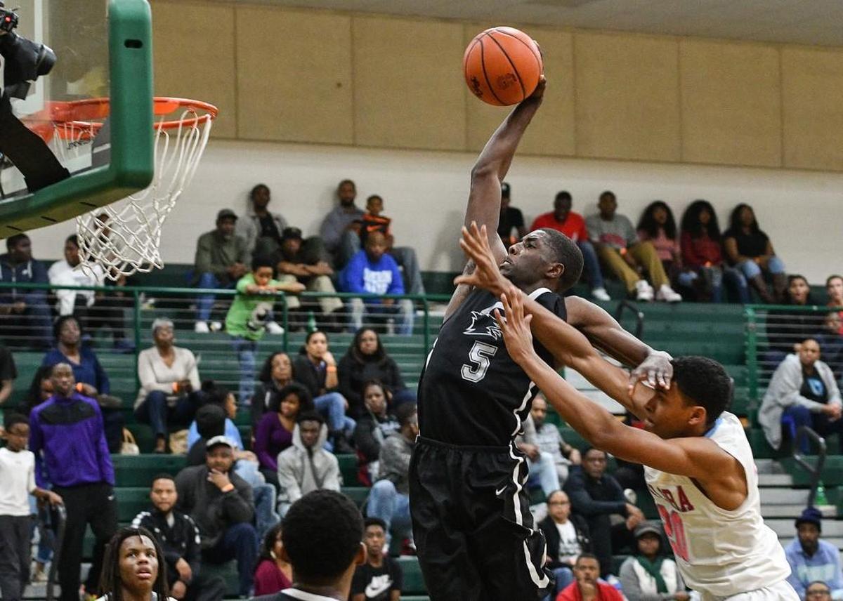 Jalek Felton (5) goes up for a dunk over A.C. Flora’s Daniel Finney (20). Felton has signed with UNC.