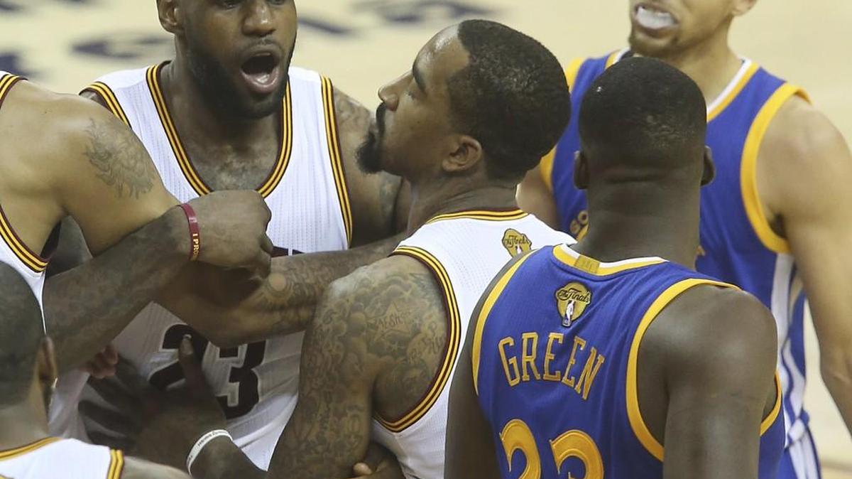 The Cleveland Cavaliers' LeBron James, left, gets tangled with the Golden State Warriors' Draymond Green, right, during the fourth quarter in Game 4 of the NBA Finals at Quicken Loans Arena in Cleveland on June 10. The Warriors won, 108-97, for a 3-1 series lead. (Phil Masturzo/Akron Beacon Journal/TNS)