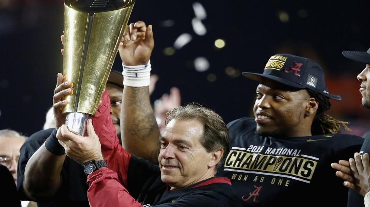 Alabama coach Nick Saban hoists the College Football Playoff National Championship Trophy after the Crimson Tide defeated the Clemson Tigers 45-40 at University of Phoenix Stadium.