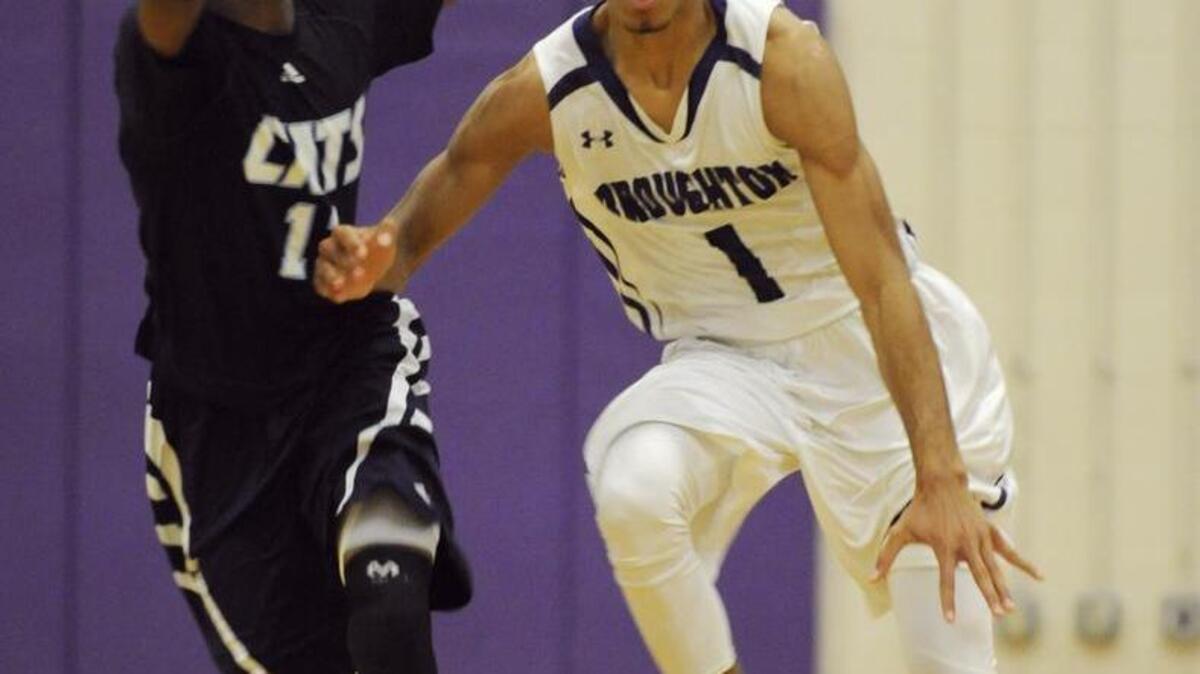 Broughton's Jerome Robinson (1) drives past Millbrook's Andrew Evans (11) at Broughton High School in Raleigh on January 30, 2015.