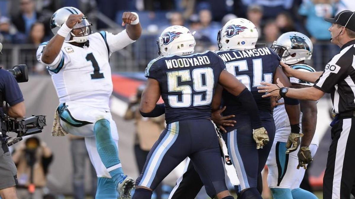 Carolina Panthers quarterback Cam Newton dances in front of Tennessee Titans defenders Wesley Woodyard (59) and Avery Williamson (54) after Newton scored a touchdown on a 2-yard run.