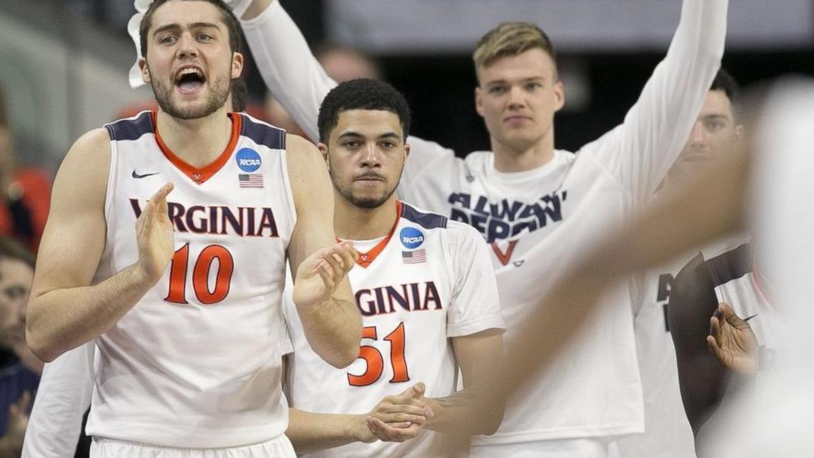 Virginia’s Mike Tobey (10) and the Cavalier bench celebrate during their NCAA Tournament win over Butler Saturday in Raleigh. The Cavs are one of four ACC teams heading to the Sweet 16.