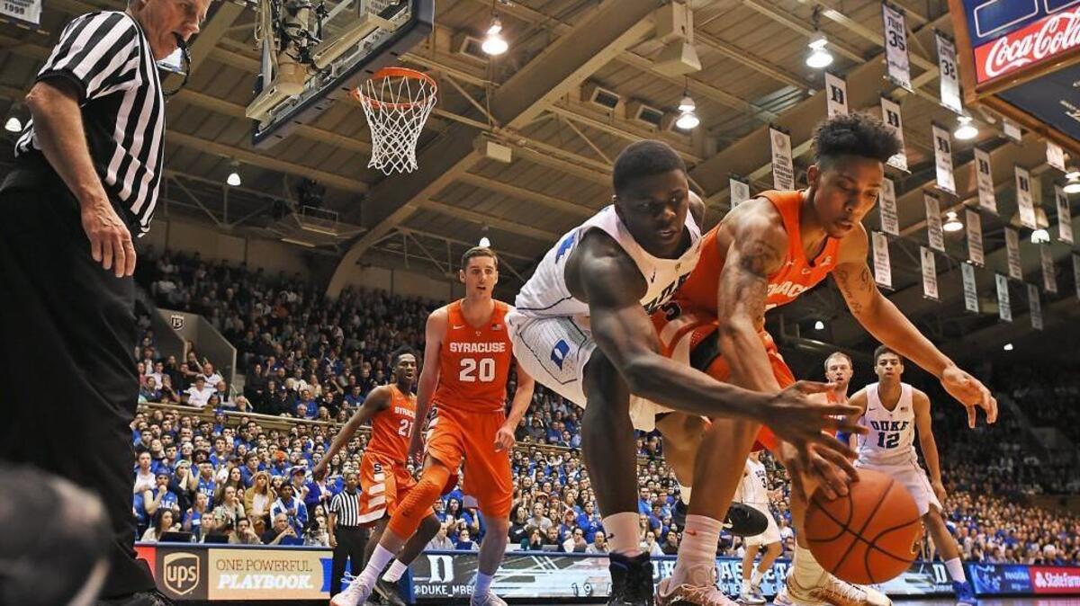 Duke forward Sean Obi (34) and Syracuse forward Tyler Roberson (21) race for a loose ball on Jan. 18 in Durham. The Orange won 64-62, which helped the team make it into the NCAA tournament.