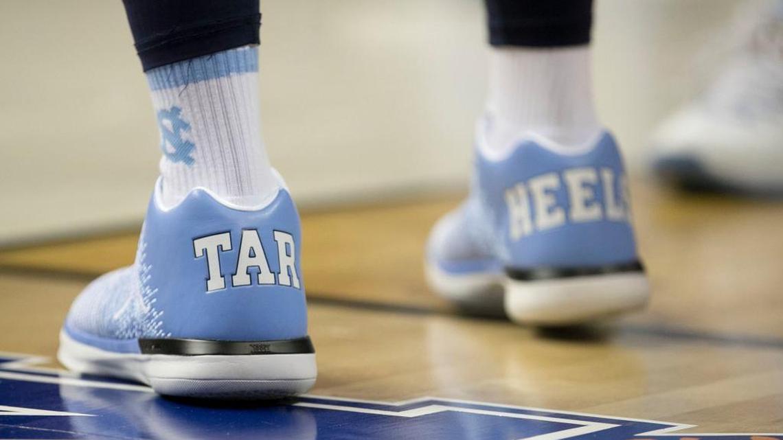 North Carolina assistant coach Hubert Davis sports custom Jumpman shoes with Tar Heels on the back during a 2017 practice.
