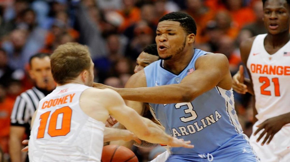 Kennedy Meeks puts pressure on Syracuse’s Trevor Cooney during the Tar Heels’ 84-73 victory on Saturday.