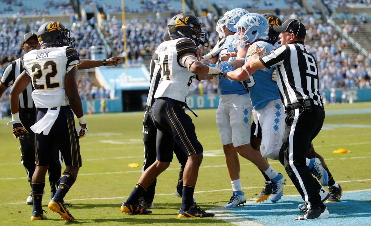 The officials come in to try to break things up as UNC's Thomas Jackson (48) and Austin Proehl (7) get into a scuffle with Cal's Camryn Bynum (24) and Traveon Beck (22) near the end of the fourth quarter.