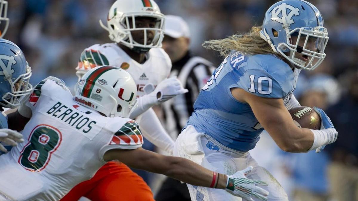UNC linebacker Jeff Schoettmer returns an interception of Miami quarterback Brad Kaaya 60 yards in the second quarter at Kenan Stadium in Chapel Hill.