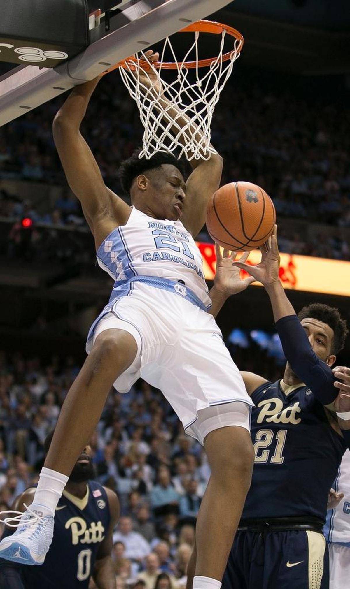 North Carolina’s Sterling Manley (21) dunks over Pitt’s Terrell Brown (21) during the first half on Saturday, February 3, 2018 at the Smith Center in Chapel Hill, N.C.