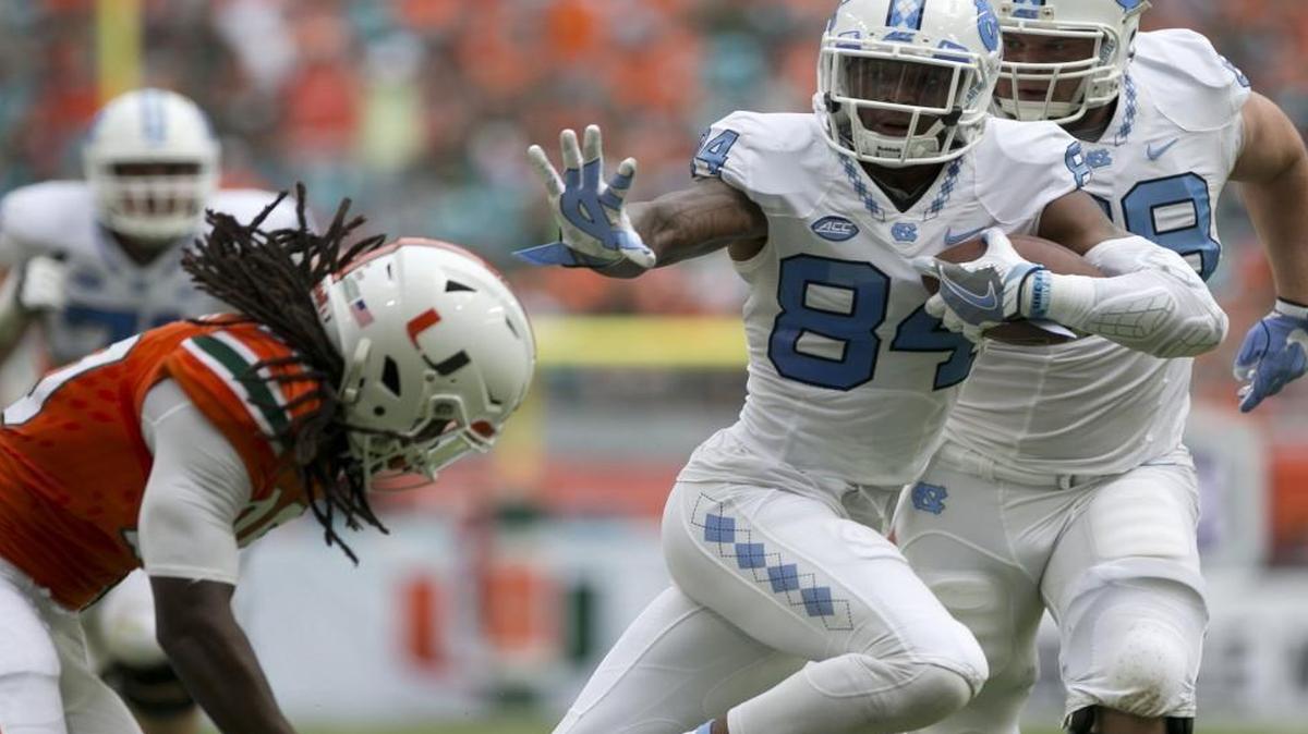 North Carolina receiver Bug Howard (84) looks for running room on a 40-yard pass play from quarterback Mitch Trubisky (10) in the first quarter against Miami.