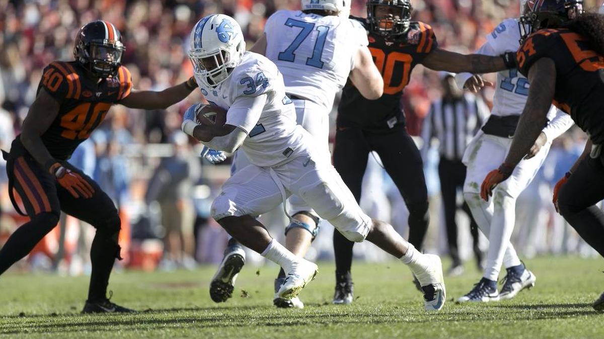 North Carolina tailback Elijah Hood (34) darts into the end zone on a 13 yard carry to score a touchdown, giving the Tar Heels a 17-10 lead over Virginia Tech in the fourth quarter on Saturday, November 21, 2015 at Lane Stadium in Blacksburg, Va.