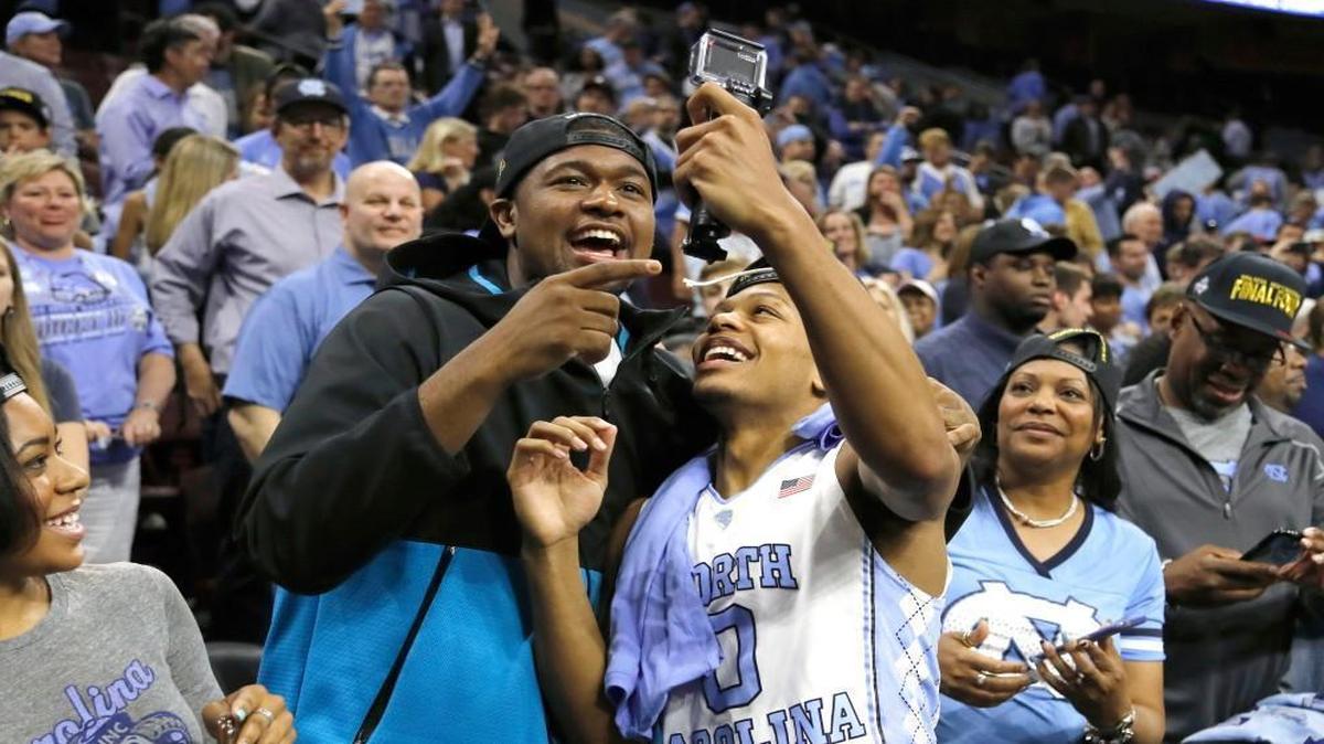 North Carolina's Nate Britt, right, and Villanova's Kris Jenkins celebrate after North Carolina won a regional final men's college basketball game against Notre Dame Sunday, March 27, 2016, in Philadelphia.