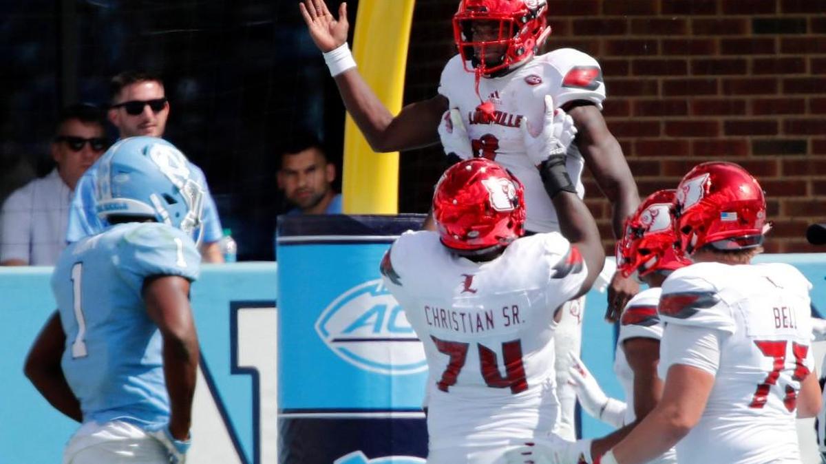 Louisville's Lamar Jackson (8) celebrates with Geron Christian (74) and Robbie Bell (75) after he scored during the fourth quarter in a game between UNC and Louisville at Kenan Stadium in Chapel Hill on Sept. 9, 2017.