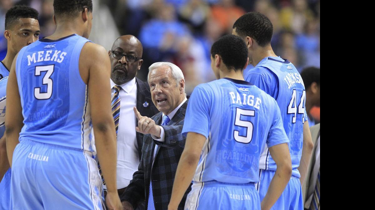 
UNC head coach Roy Williams talks to his team including Kennedy Meeks (3), Marcus Paige (5) and Justin Jackson (44) during a timeout during the semifinals of the 2015 New York Life ACC Tournament at the Greensboro Coliseum in Greensboro, March 13, 2015.
