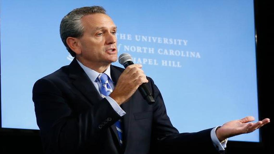 
UNC athletic director Bubba Cunningham speaks at a press conference as UNC chancellor Carol Folt looks on after a presentation of the Wainstein report, an investigation into academic fraud at UNC on October 22, 2014. 
