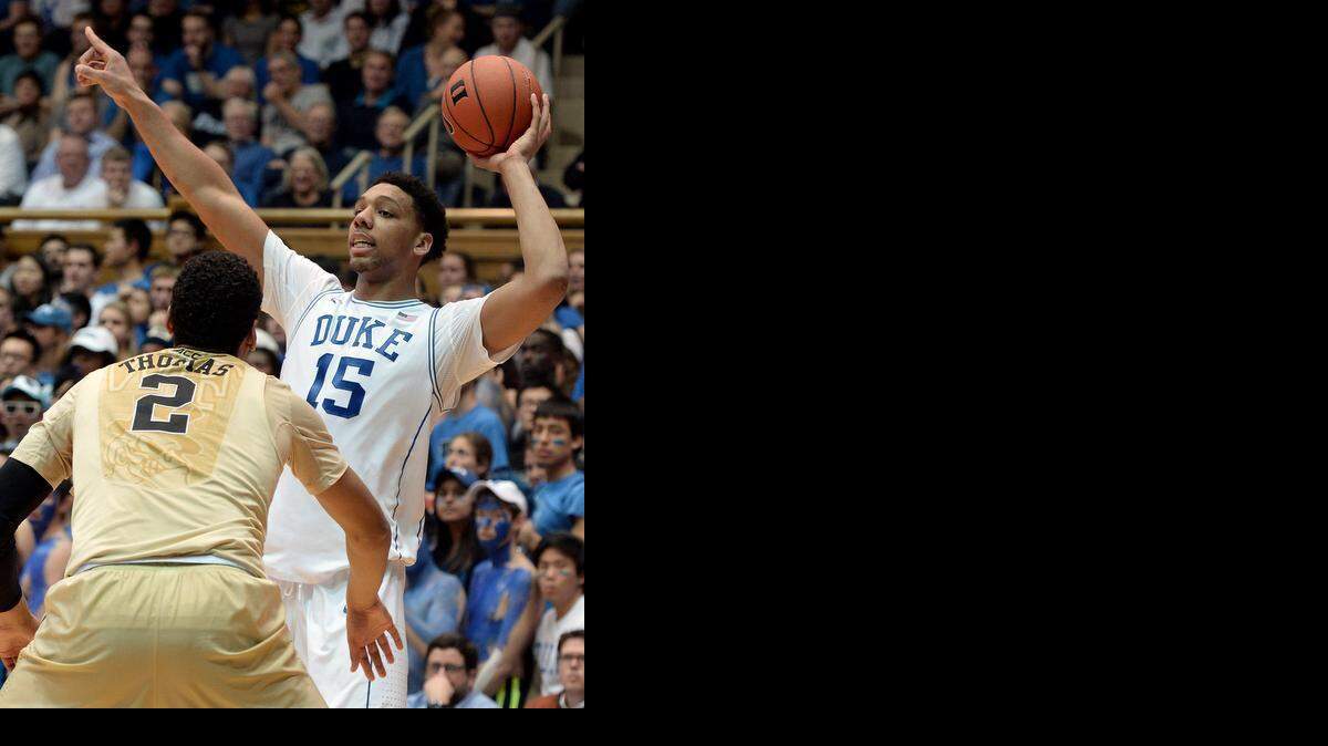 
Duke center Jahlil Okafor (15) directs players as he looks to pass as Wake Forest forward Devin Thomas (2) defends in the first half. Duke played Wake Forest University on Wednesday at Cameron Indoor Stadium in Durham.
