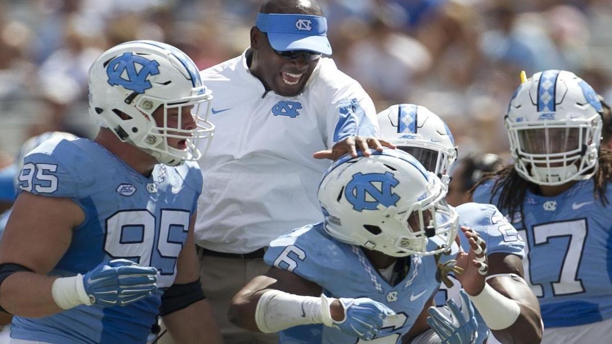 North Carolina defensive backs coach Carlton Warren congratulates M.J. Stewart (6) after is interception of Illinois quarterback Wes Lunt in 2015.