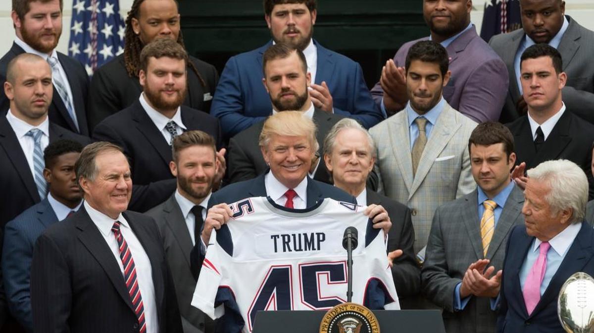 President Donald Trump holds a Patriots Super Bowl jersey next to coach Bill Belichick, left, and owner Robert Kraft, right, as he welcomes during a celebration at the White House in April for New England’s February Super Bowl win.