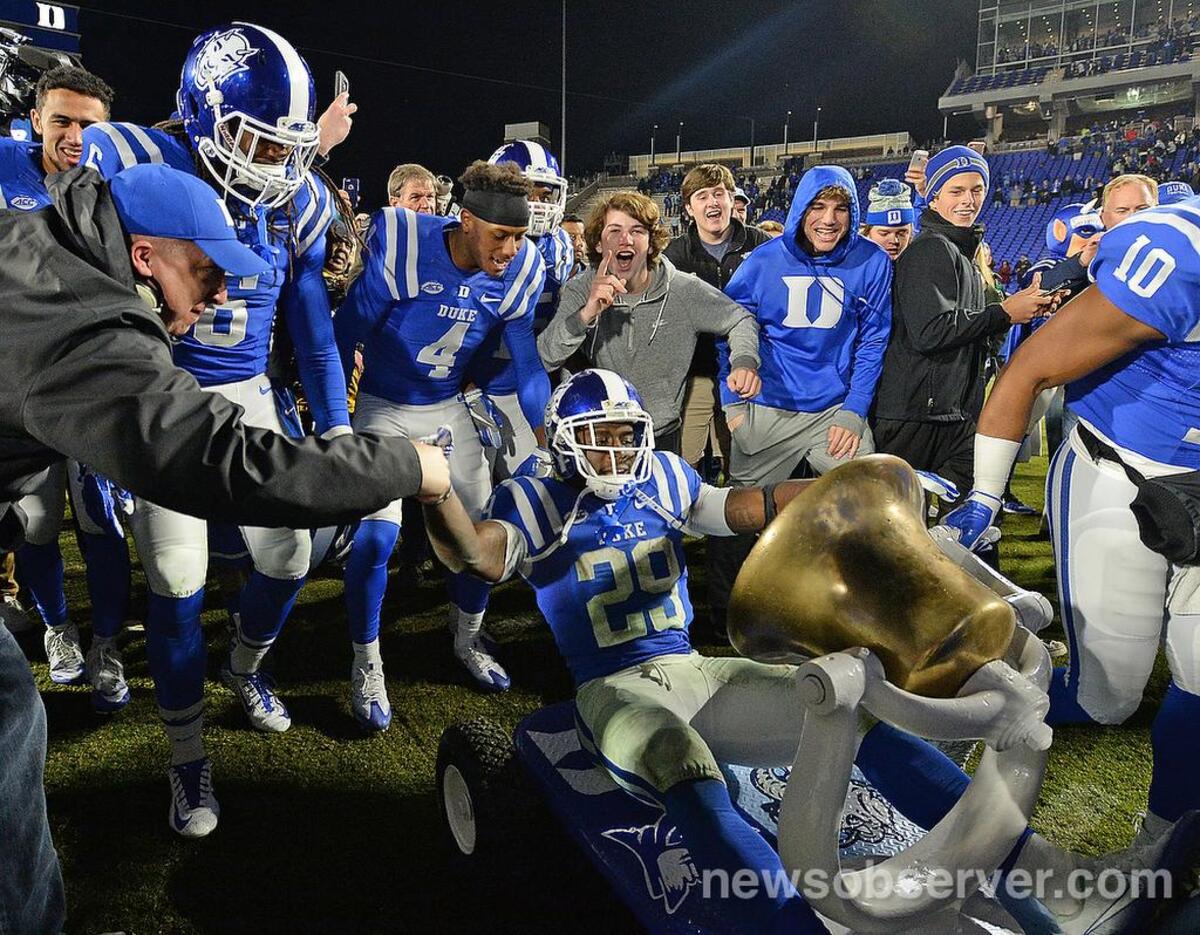 Duke running back Shaun Wilson (29) takes a ride on the Victory Bell after Duke beat North Carolina 28-27 at Walllace Wade Stadium in Durham, N.C. , Thursday, Nov. 10, 2016.