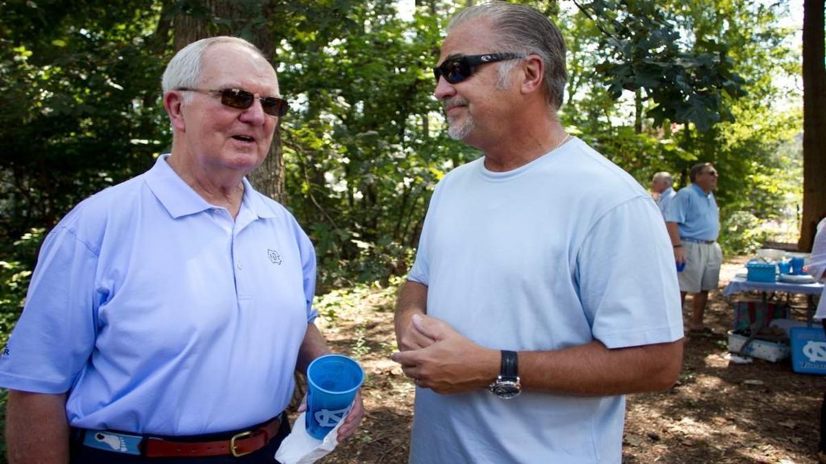 Woody Durham talks with former Tar Heel basketball player Dick Grubar while tailgating outside Kenan Stadium before a football game against Pittsburgh on Sept. 24, 2016, in Chapel Hill, N.C.