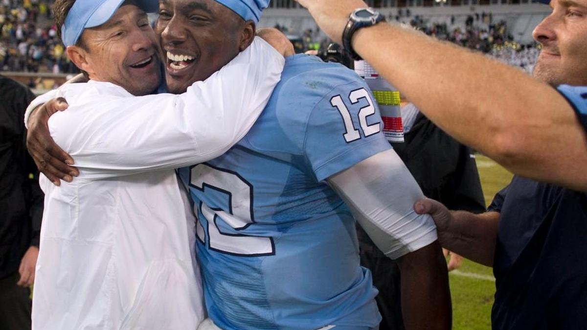 North Carolina coach Larry Fedora and offensive line coach Chris Kapilovic embrace quarterback Marquise Williams (12) after the Tar Heels 41-38 win over Georgia Tech on Oct. 3. UNC’s coaches and players have a short week to prepare for the team’s Thursday night matchup at Pitt.