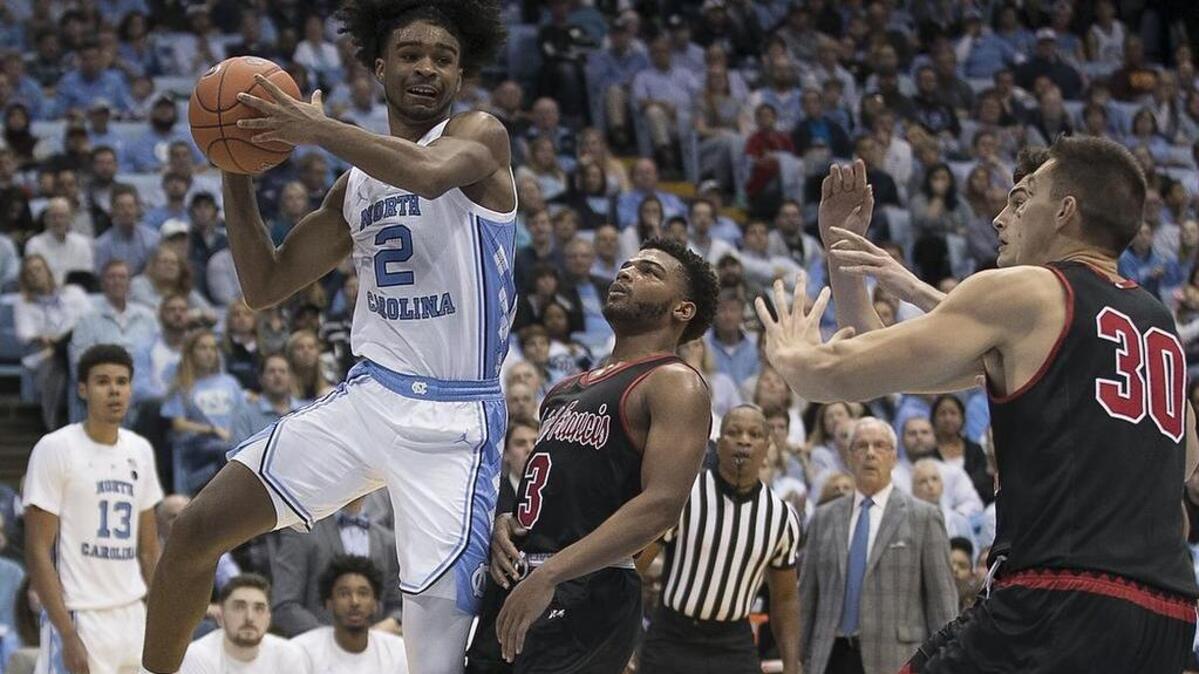 North Carolina’s Coby White (2) drives to the basket against St. Francis’ Jamaal King (3) in the second half on Monday, November 19, 2018 at the Smith Center in Chapel Hill, N.C.