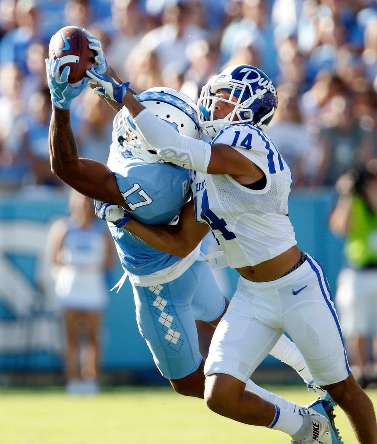 UNC's Anthony Ratliff-Williams (17) hauls in a long pass against Duke's Bryon Fields Jr. (14) during the second quarter.