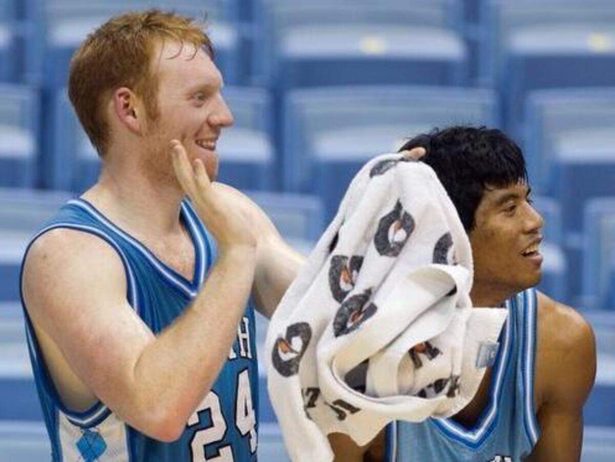 
UNC JV team members Dalton Spenser (24) and Andrew Ocampo (34) applaud the play of their teammates during their season opening game against Mt. Olive on November 1, 2013 at the Smith Center in Chapel Hill, N.C.
