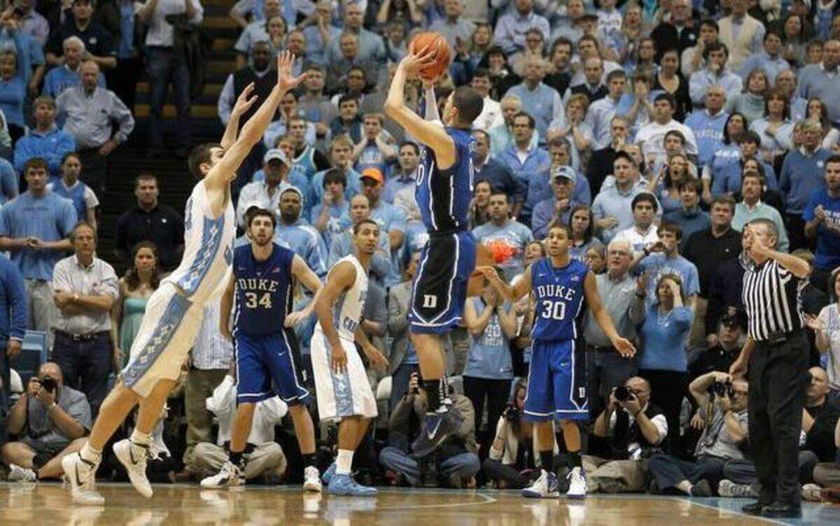 
Duke guard Austin Rivers (0) launches a three pointer as UNC forward Tyler Zeller (44) attempts to defend to win the game 85-84 at the Smith Center on Feb. 8, 2012.

