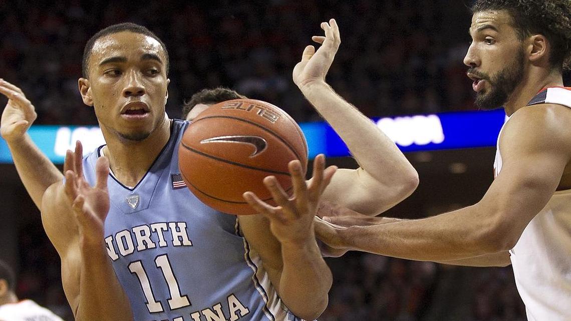 Virginia’s Anthony Gill (13) puts pressure on North Carolina’s Brice Johnson (11) during the second half at John Paul Jones Arena on Saturday, February 27, 2016 in Charlottesville, Virginia.