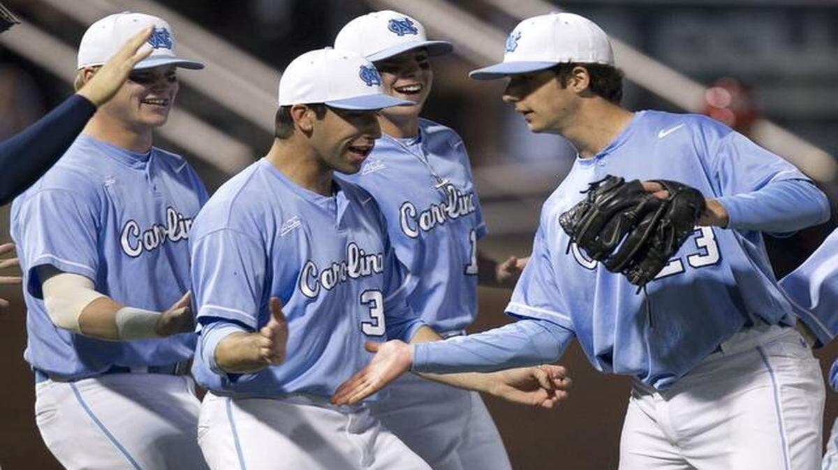 
North Carolina pitcher Zac Gallen, right, is congratulated by his teammates, including Jack Geraghty, center, after pitching a complete game in the Tar Heels’ 2-1 win over N.C. State on Friday at Boshamer Stadium in Chapel Hill,.
