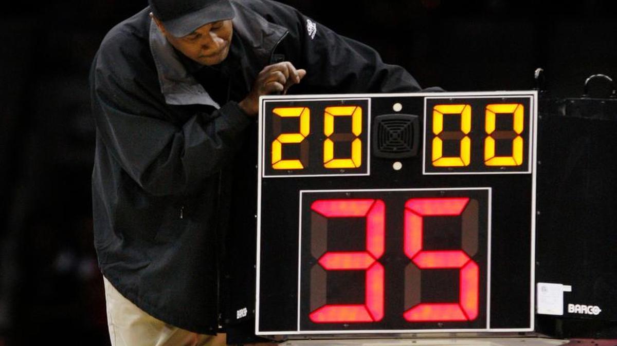 
In this March 19, 2010, file photo, a technician adjusts a shot clock after it malfunctioned and delayed the start of the California against Louisville NCAA first-round college basketball game in Jacksonville, Fla. The NCAA men's basketball rules committee completes this week's meetings by announcing its recommendations for changes Friday, May 15, 2015. They're expected to reduce the shot clock from 35 to 30 seconds and look for ways to speed up the end of games.(AP Photo/Steve Helber, File)
