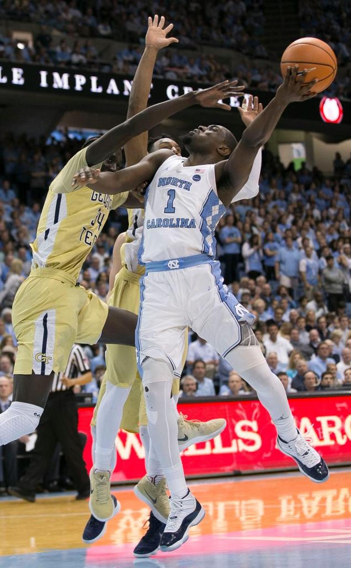 North Carolina’s Theo Pinson (1) drives to the basket past Georgia Tech’s Abdoulaye Gueye (34) and Josh Okogie (5) during the second half on Saturday, January 20, 2018 at the Smith Center in Chapel Hill, N.C. Pinson scored ten points and secured 11 rebounds in the Tar Heels’ 80-66 victory.