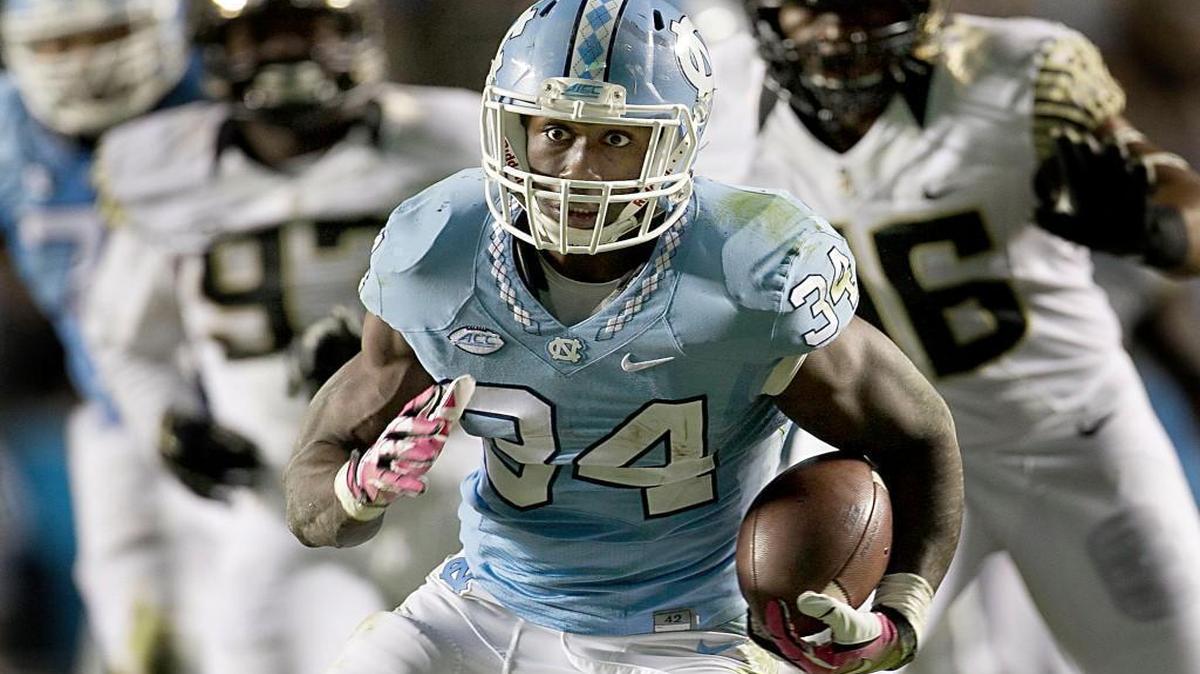 
North Carolina tailback Elijah Hood (34) looks for running room against Wake Forest in the second quarter, pulling away from the Demon Deacon defense for a 36-yard touchdown.
