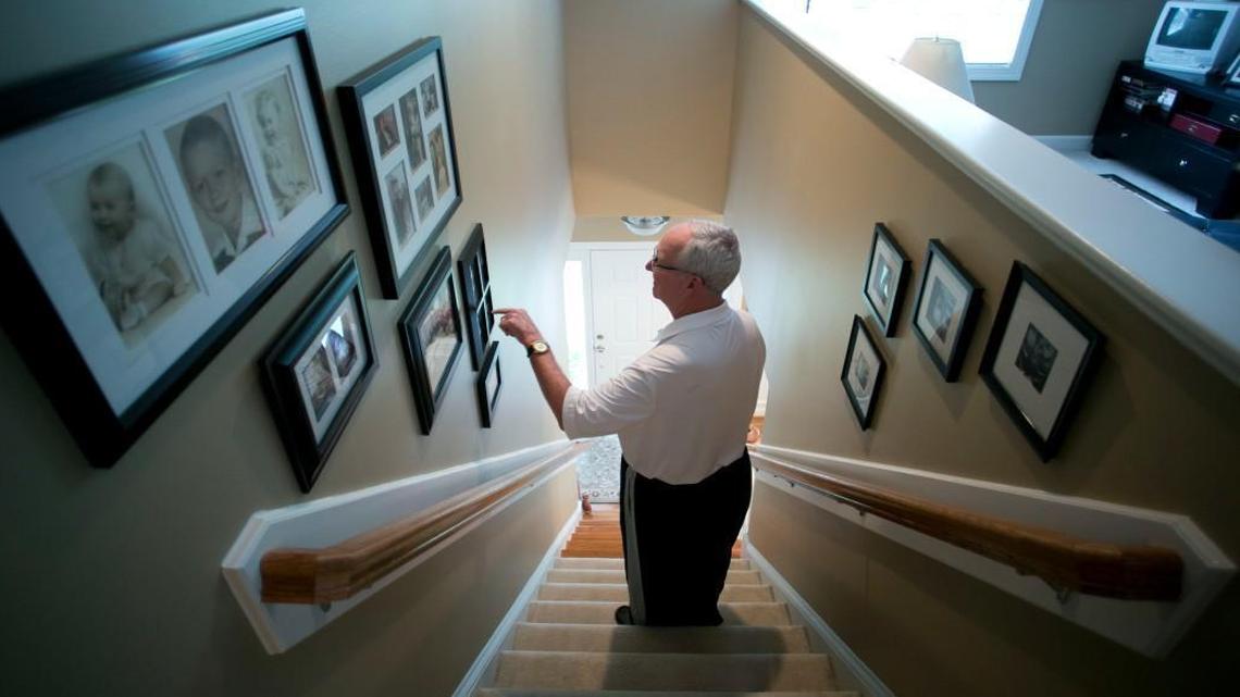 Woody Durham stops to look over photographs and connect names with faces in his home on Sept. 28, 2016 in Chapel Hill, N.C.