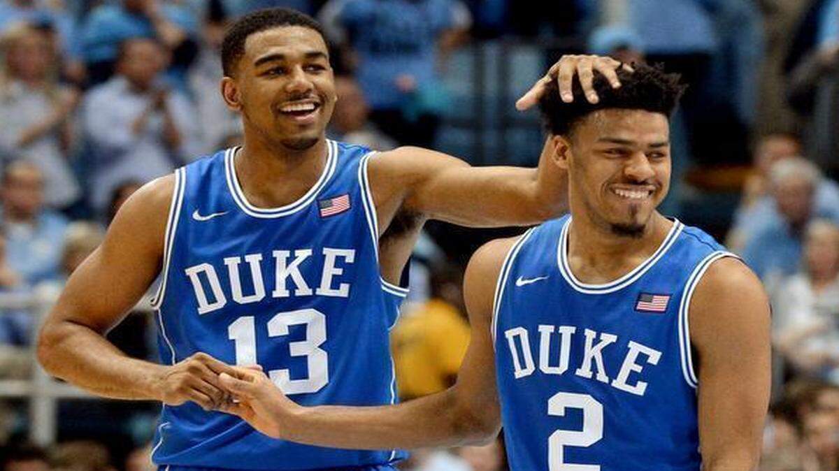 
Duke’s Matt Jones (13) celebrates with teammate Quinn Cook as the Blue Devils defeat UNC 84-77 at the Dean Smith Center in Chapel Hill.
