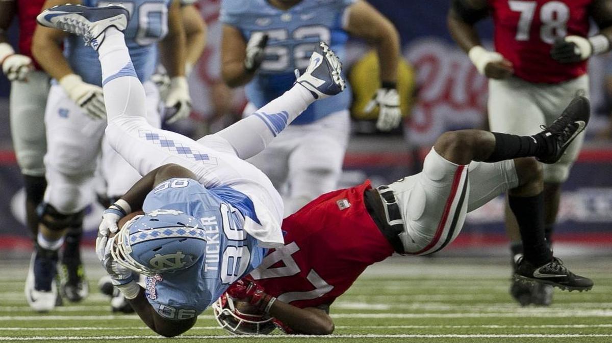 Georgia’s Dominick Sanders stop North Carolina’s Carl Tucker in the first quarter at the Georgia Dome in Atlanta,.