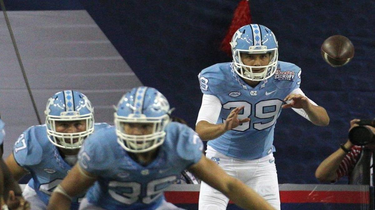 North Carolina punter Tom Sheldon, right, gets the snap from deep snapper Tommy Bancroft during the fourth quarter against Georgia on Sept. 3. Sheldon, who’s a 27-year-old freshman, is one of many punters coming to the U.S. from Australia.