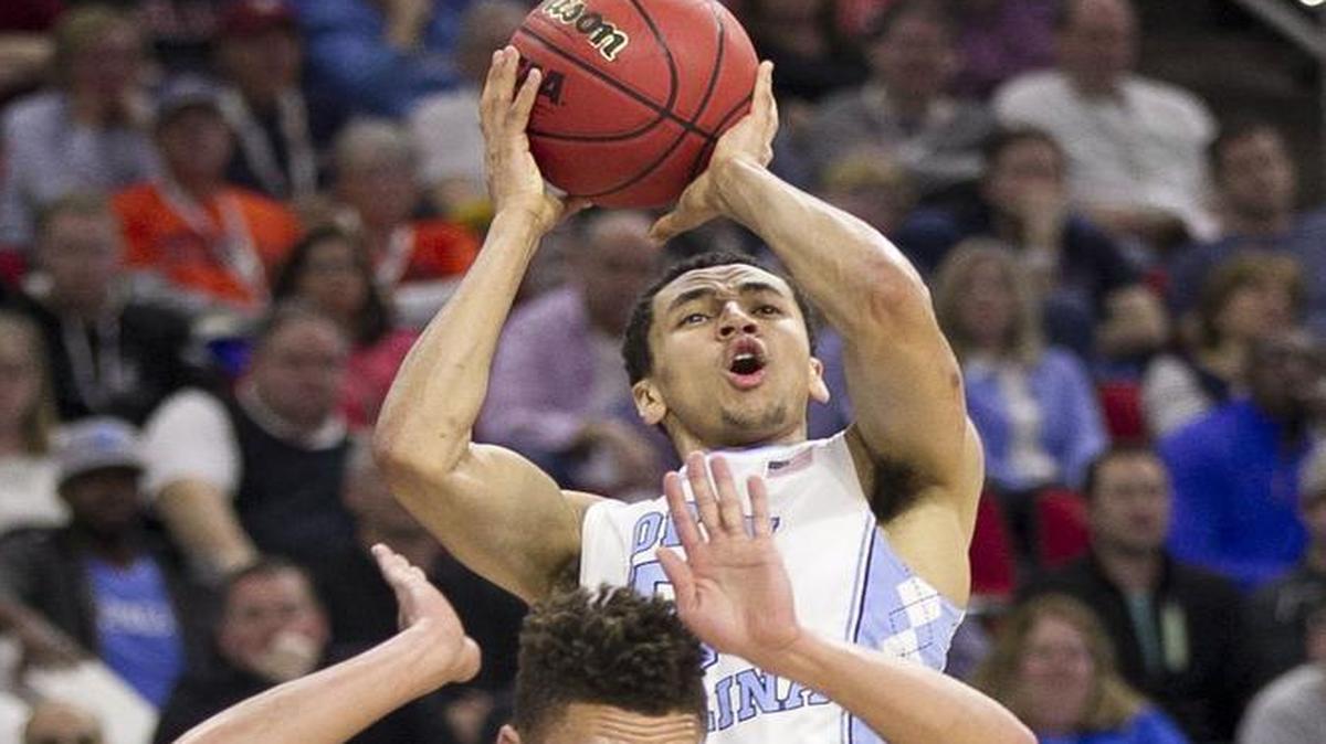 North Carolina’s Marcus Paige (5) puts up a 3-point shot and draws a foul from Providence’s Drew Edwards (25) during the first half of the second round of the NCAA Tournament at the PNC Arena in Raleigh.