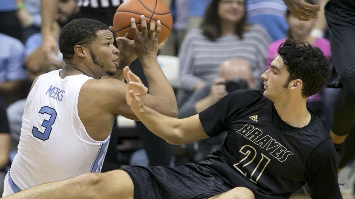 North Carolina’s Kennedy Meeks (3) hits the court to secure a loose ball with Pembroke’s Carson Mounce during the first half at the Smith Center in Chapel Hill.