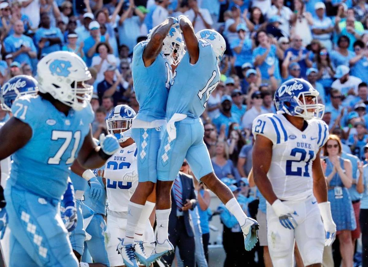 UNC's Anthony Ratliff-Williams (17) celebrates his TD with Logan Byrd (14) while Duke's Alonzo Saxton II (21) walks away.