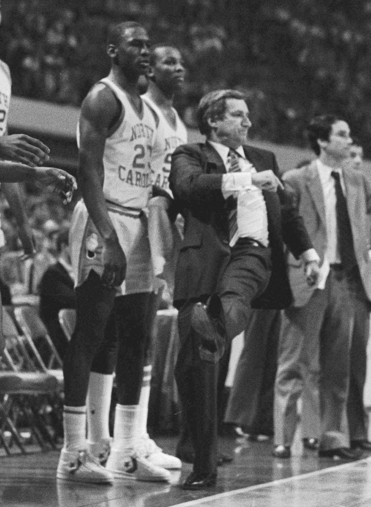 Michael Jordan, left, and coach Dean Smith watch the end of their 72-68 loss to Indiana in the NCAA East Regional semifinals in Atlanta on March 22, 1984 photo.