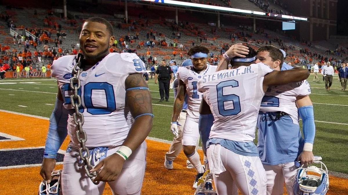 North Carolina’s Nazair Jones (90) leaves the field as teammates Ryan Switzer (3) and M.J. Stewart (6) embrace after their 48-23 victory over Illinois on Saturday, Sept. 10, 2016 at Memorial Stadium in Champaign, Ill.