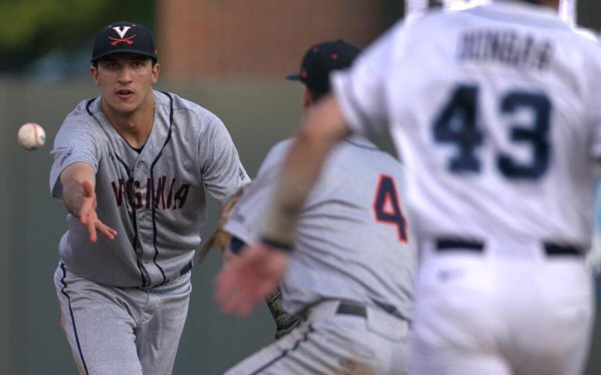 
Virginia short stop Daniel Pinero (22) tosses a fielded hit by North Carolina's Logan Warmoth to second baseman Ernie Clement (4) to force out Korney Dunbar (43) at second base in the second inning inning at Boshamer Staadium in Chapel Hill.

