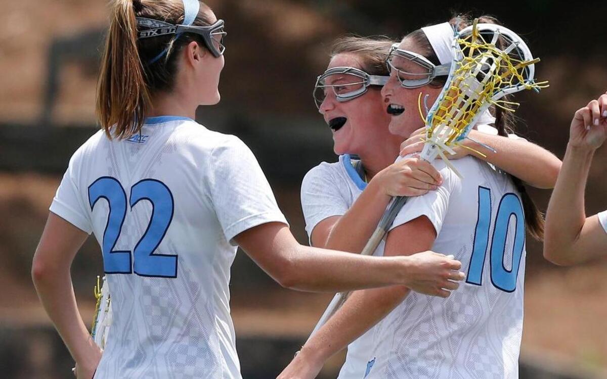 
North Carolina's Sydney Holman (10), right, is congratulated by Sam McGee (7), center, and Maggie Bill (22) after Holman scored to put UNC up 9-8 during the second half of UNC's 11-8 victory over Penn State in the NCAA women's college lacrosse quarterfinals at Fetzer Field in Chapel Hill, N.C., Saturday, May 16, 2015.
