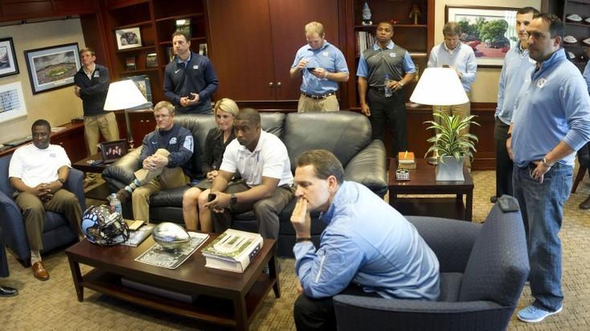 North Carolina coach Larry Fedora and his staff gather in Fedora’s office to watch Nate Craig-Myers’s signing day announcement on ESPNU on Feb. 3. Craig-Myers picked Auburn over UNC.