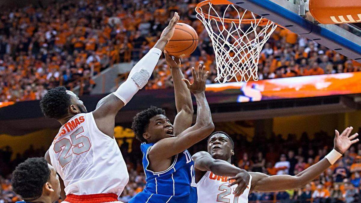 
Duke’s Justise Winslow (12) is fouled by Syracuse’s Tyler Roberson (21) as Rakeem Christmas (25) also defends, during the second half of a Feb. 14, 2015, game at The Carrier Dome in Syracuse, New York. Duke defeated Syracuse 80-72.
