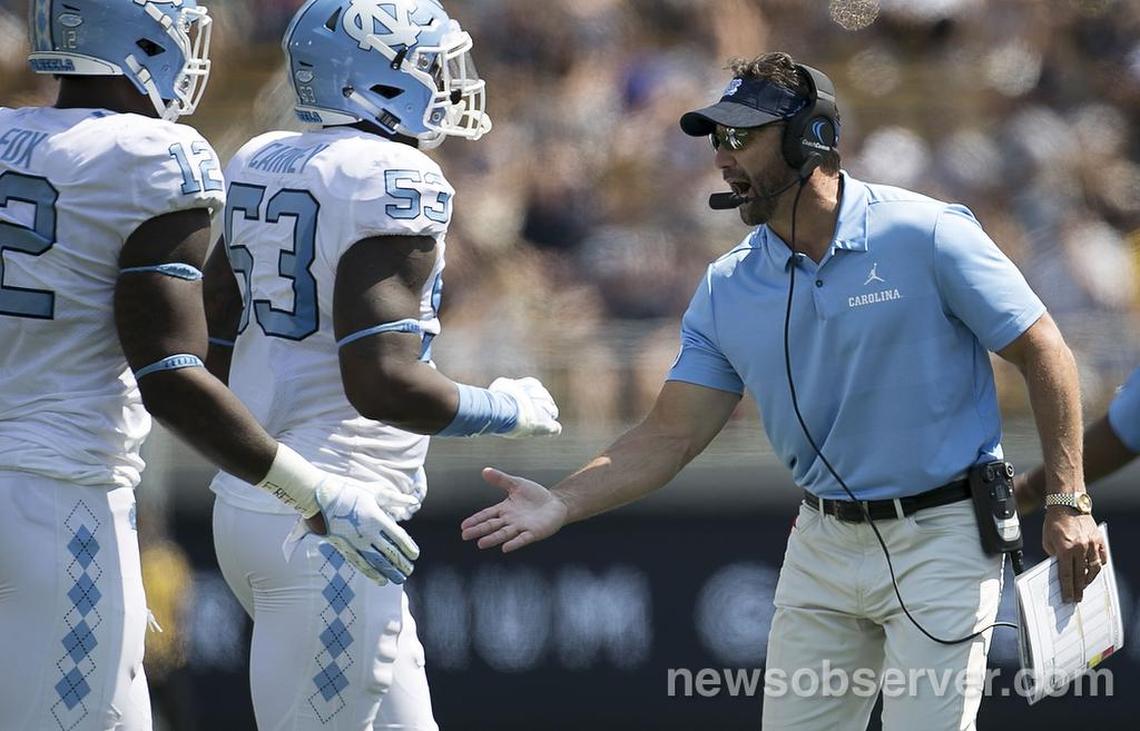 North Carolina coach Larry Fedora congratulates Malik Carney (53) of the defensive unit after holding California to a field goal in the second quarter on Saturday, Sept. 1, 2018, at Memorial Stadium in Berkeley, Ca.